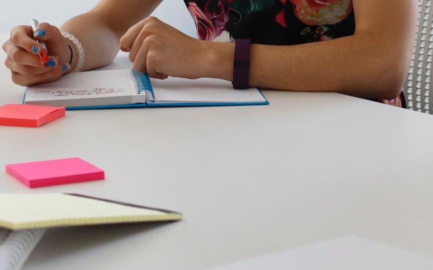 A person sitting at a table using a laptop