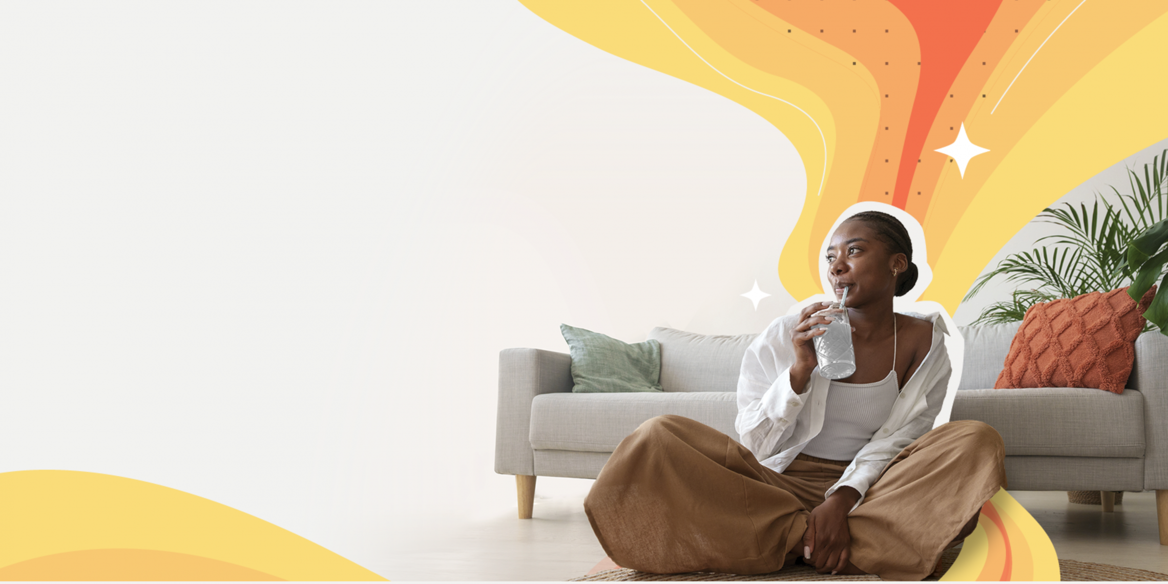 Woman sitting on floor drinking water and looking hopeful with golden aura emanating behind her