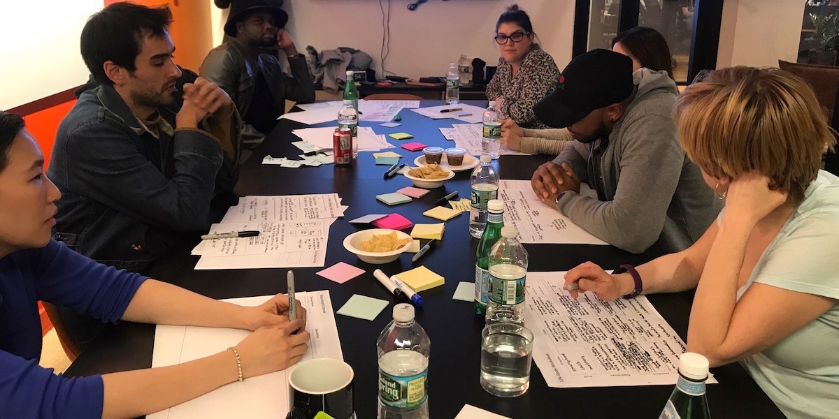 a group of millennials sitting around a table doing design research