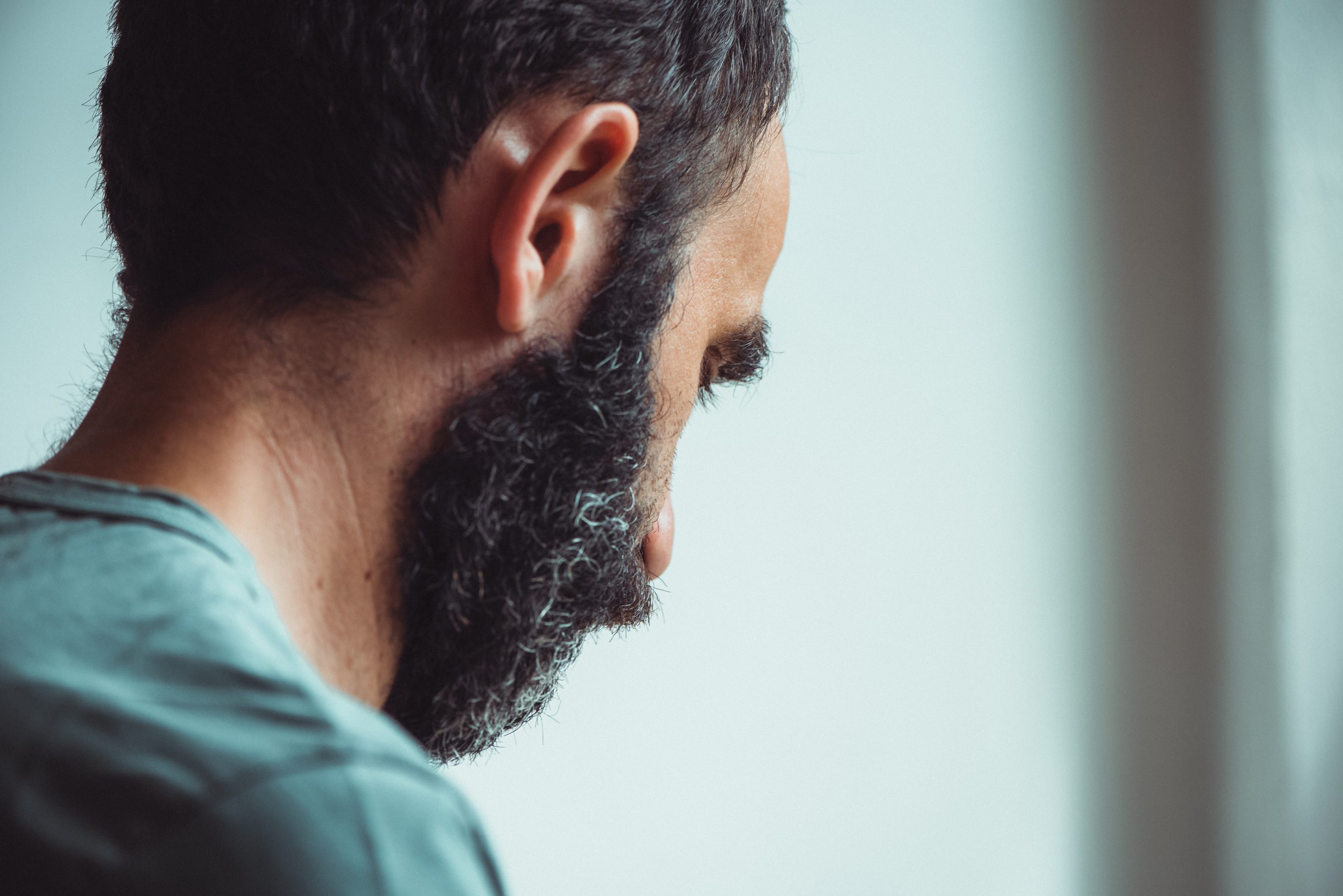 Portrait: A man in profile while he is working, falling prey to the insurance industry's people problem